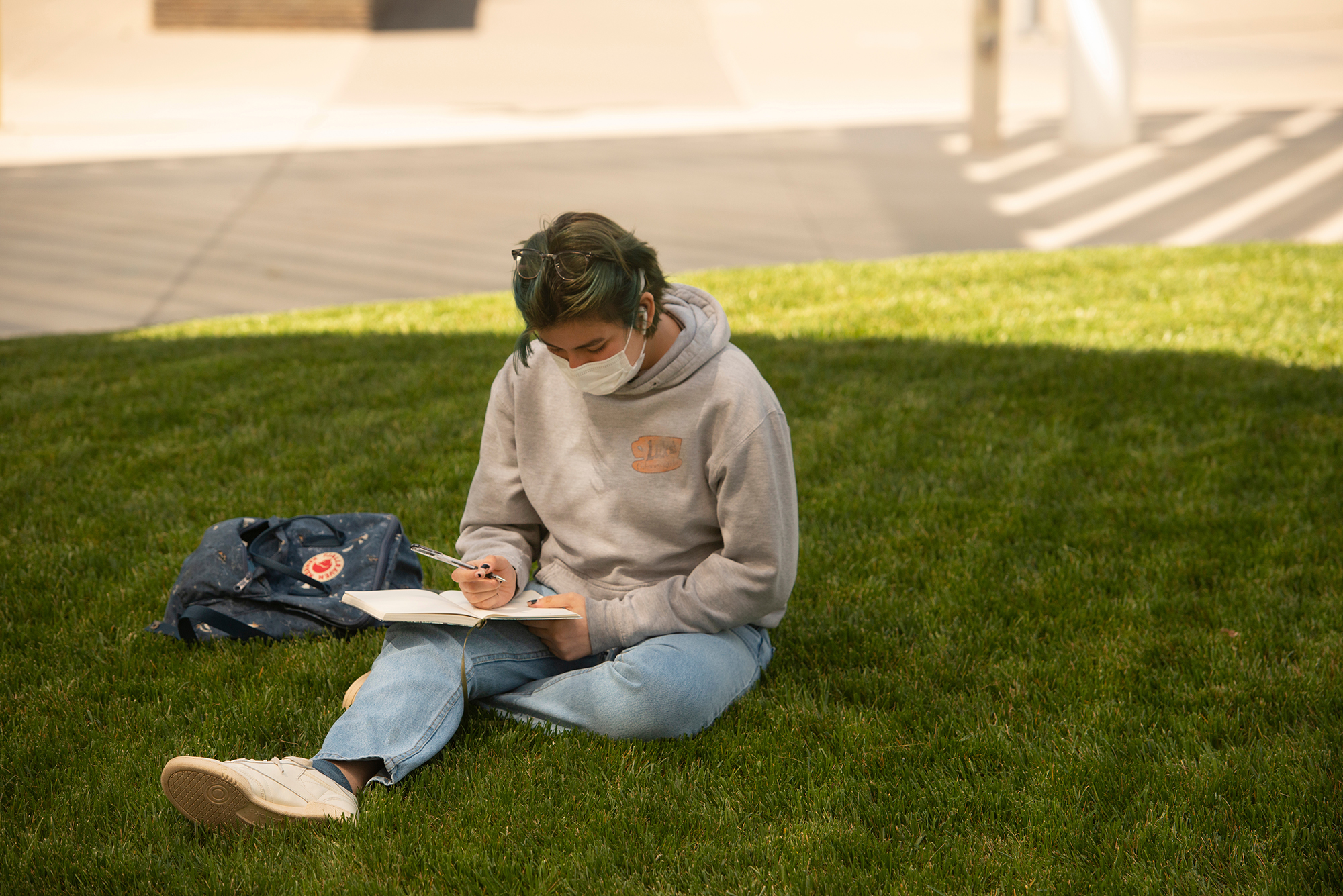 Student studying on the grass