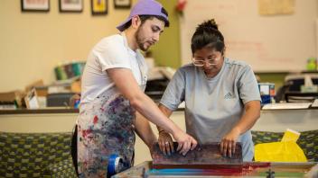 Students screen printing at kickoff event