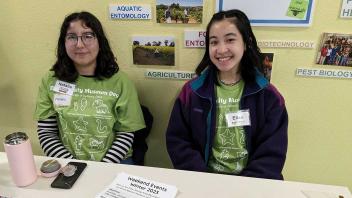 Two UC Davis College Corps students tabling at an event