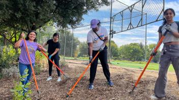 Four UC Davis College Corps students working outdoors