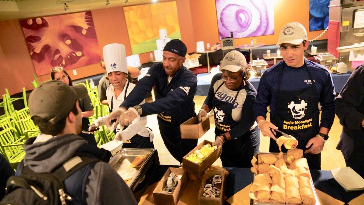 Campus leadership serve food at Aggie Moonlight Breakfast