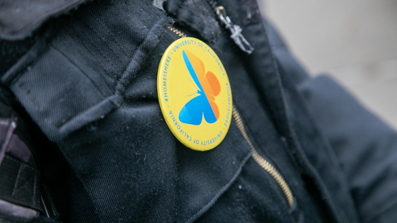 someone wearing a button in support of Undocumented Students