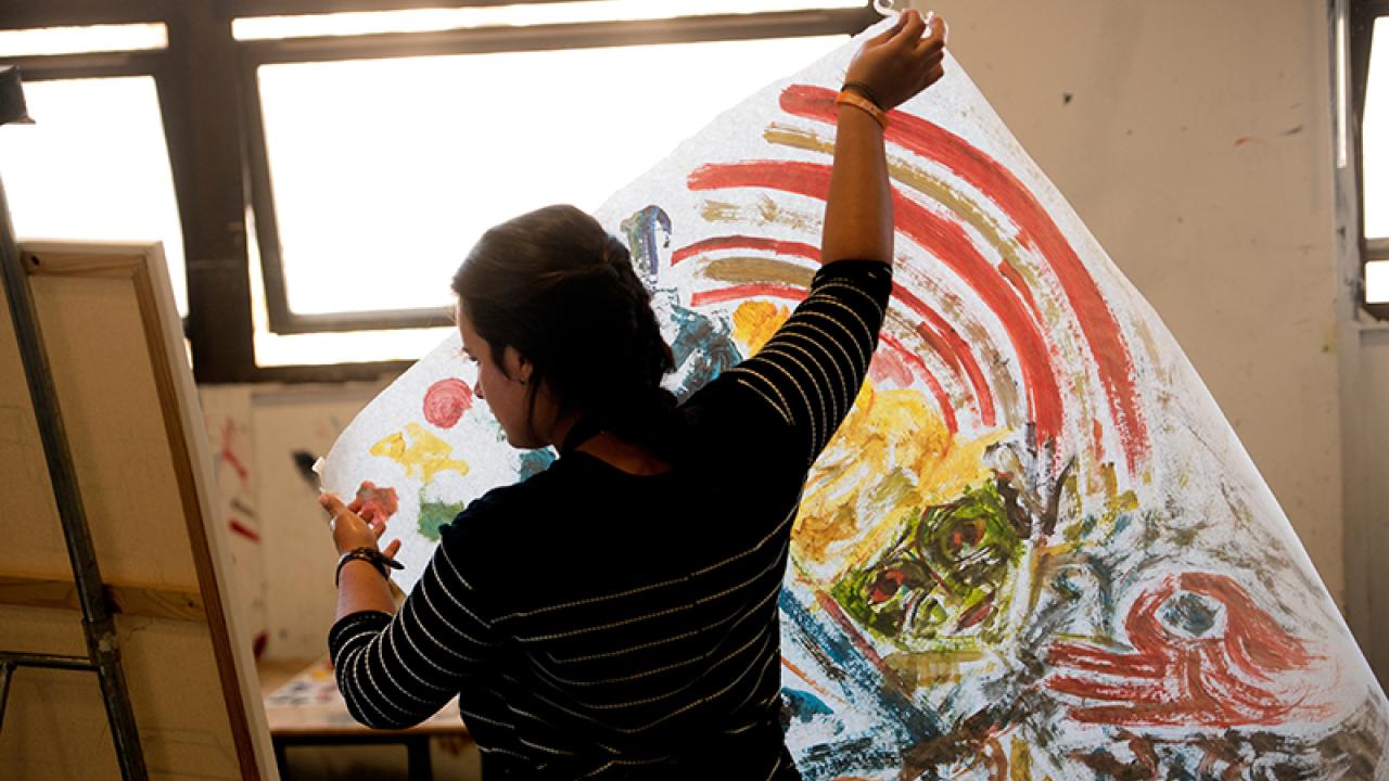 Student carrying an artwork