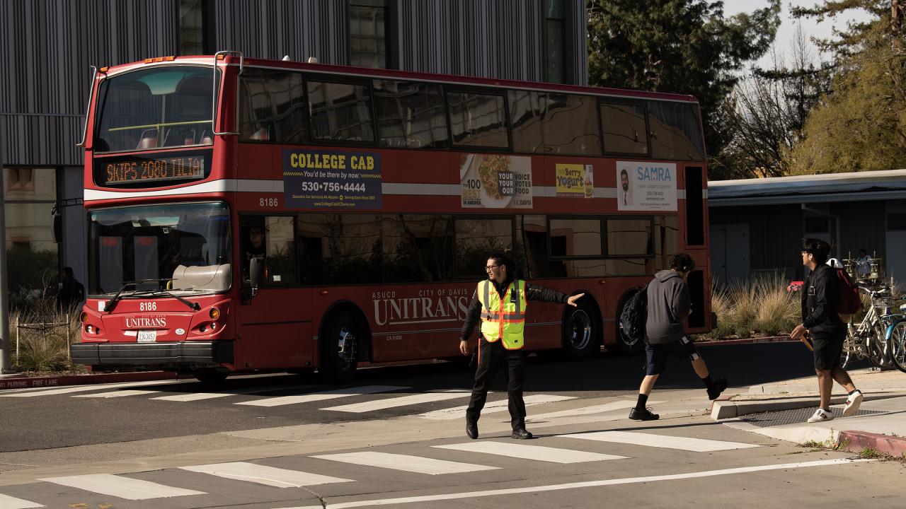 Crossing Guard and Double Decker Bus Slightly Larger