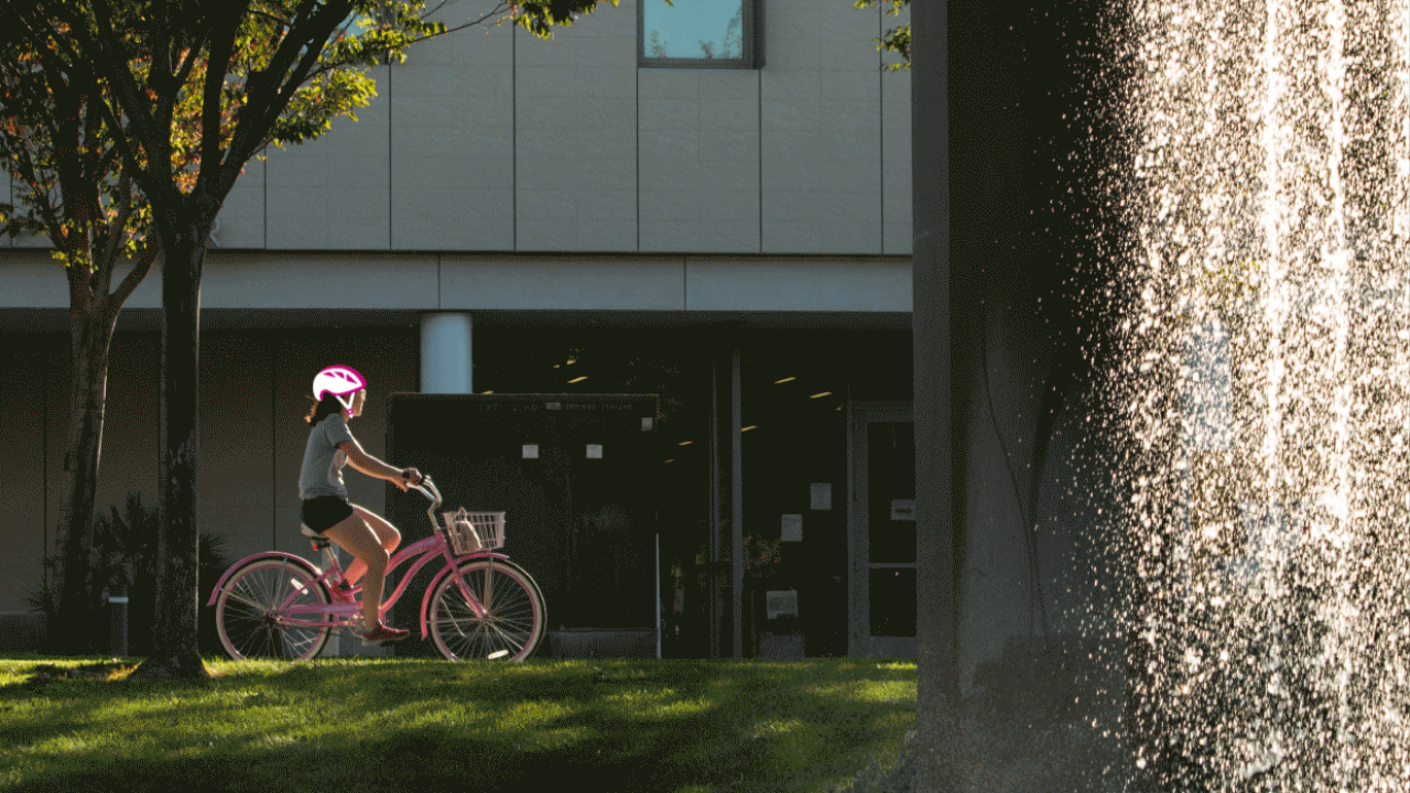 Student biking on campus