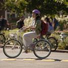 Student riding bike and wearing helmet.