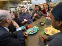 students eating lunch with a faculty member