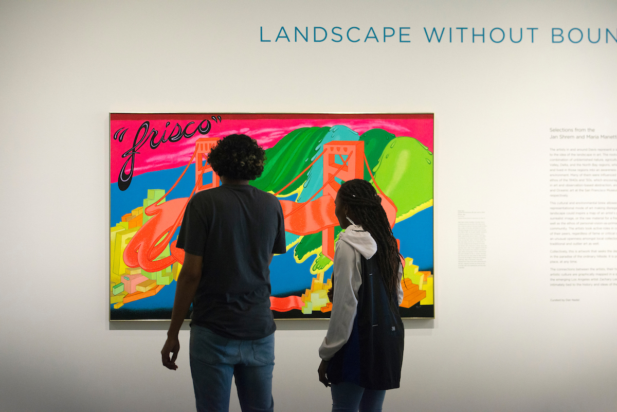 Students look at a painting in the Manetti Shrem Museum