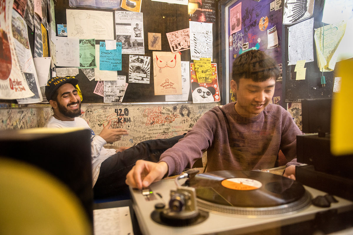 Two KDVS students play music in KDVS headquarters