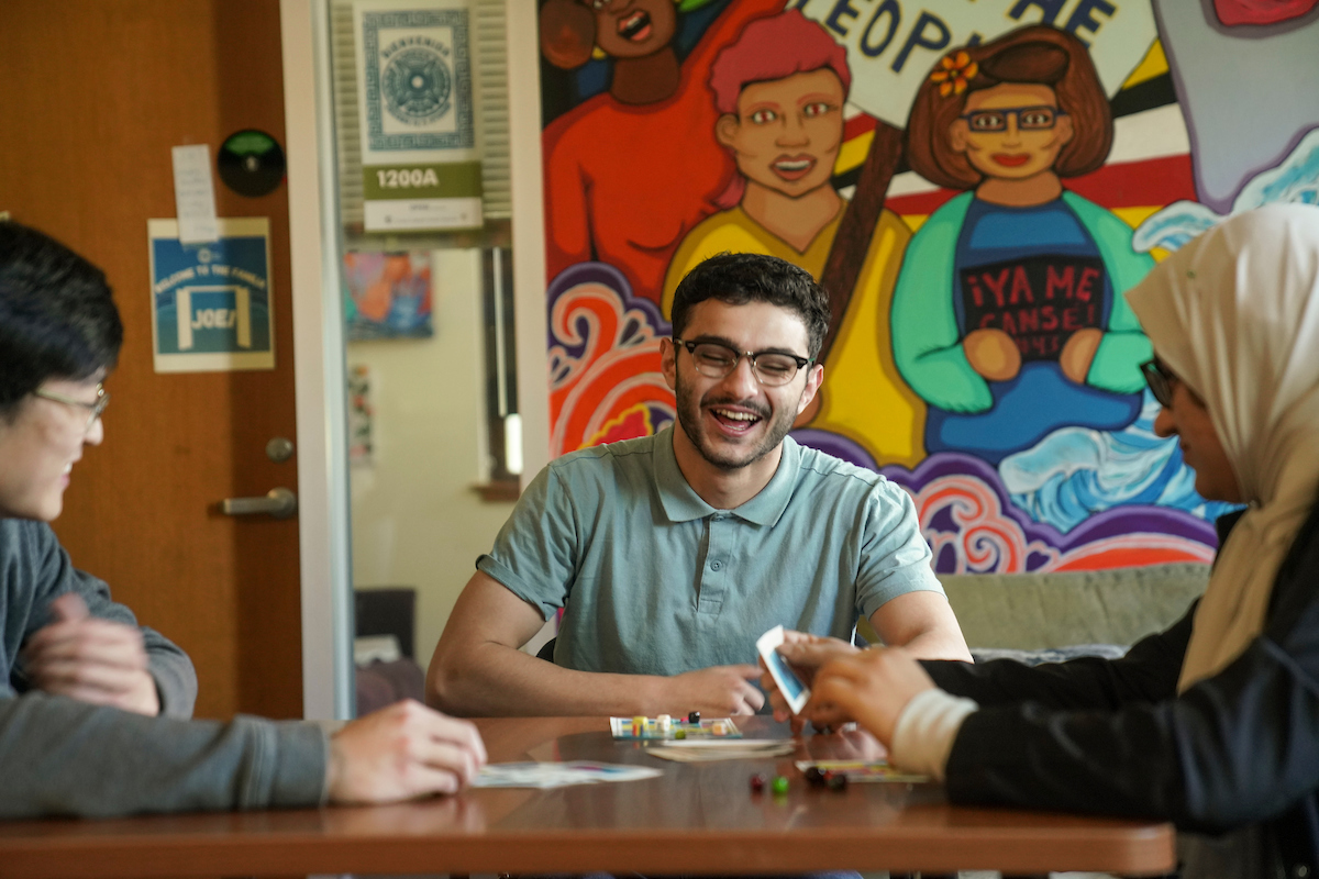 3 students play Loteria in the Cross Cultural Center