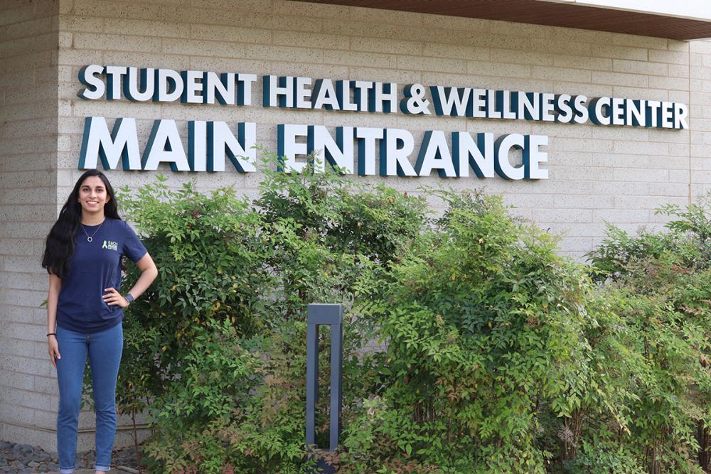Roshni Desai standing in front of the Student Health and Wellness Center