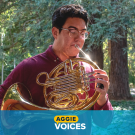 Michael Petris plays the french horn in the Arboretum