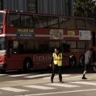 Crossing Guard and Double Decker Bus Slightly Larger